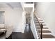 Open-concept hallway with hardwood floors and staircase, connecting to the dining room and other living areas at 6540 Muirfield Pt, Fairburn, GA 30213