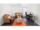 Brightly lit living room with hardwood floors, sofas and a work space at 6540 Muirfield Pt, Fairburn, GA 30213