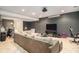 Spacious living room featuring large comfortable sectional sofa and media setup at 6540 Muirfield Pt, Fairburn, GA 30213