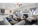 Open-concept living room with hardwood floors, fireplace, and plenty of natural light at 6540 Muirfield Pt, Fairburn, GA 30213