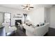 Bright living room featuring hardwood floors, a fireplace, and neutral-toned furniture at 6540 Muirfield Pt, Fairburn, GA 30213