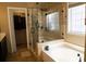 Bathroom with soaker tub, glass shower, and walk-in closet at 681 Nine Oaks Cir, Villa Rica, GA 30180
