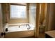 Bathroom features tiled walls, a garden tub, and a separate toilet at 681 Nine Oaks Cir, Villa Rica, GA 30180