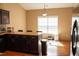 Bright kitchen with a modern light fixture and dark wood cabinets, offering plenty of counter space at 681 Nine Oaks Cir, Villa Rica, GA 30180