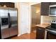 Stainless steel refrigerator in kitchen with dark cabinets and light tan walls at 681 Nine Oaks Cir, Villa Rica, GA 30180