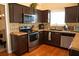 Kitchen featuring stainless steel appliances, granite countertops, and dark wood cabinets at 681 Nine Oaks Cir, Villa Rica, GA 30180