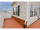 Exterior view showcasing the backyard with vinyl siding and a red brick perimeter wall at 102 Manley Ct, Woodstock, GA 30188