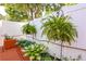 Backyard with privacy fence, hanging ferns, and brick planter at 102 Manley Ct, Woodstock, GA 30188