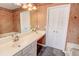Bathroom boasts stylish wallpaper, large mirror, and ample counter space at 102 Manley Ct, Woodstock, GA 30188
