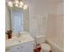 Bright bathroom featuring a white vanity, updated lighting fixtures and a tub with a shower at 102 Manley Ct, Woodstock, GA 30188