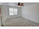 Comfortable bedroom with plush carpeting, a ceiling fan, and natural light from a window at 102 Manley Ct, Woodstock, GA 30188