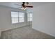 Comfortable bedroom with plush carpeting, a ceiling fan, and natural light from a window at 102 Manley Ct, Woodstock, GA 30188