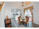 Charming dining area with a modern table, stylish chairs, view of the kitchen, light fixture, and natural light at 102 Manley Ct, Woodstock, GA 30188