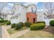 Charming two-story home with a brick entryway and lush landscaping at 102 Manley Ct, Woodstock, GA 30188
