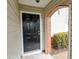 Stylish front door with brick archway, offering a peek into the home's welcoming entrance at 102 Manley Ct, Woodstock, GA 30188