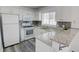 Modern kitchen featuring white cabinets, granite countertops, and stainless steel appliances at 102 Manley Ct, Woodstock, GA 30188