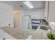 Eat-in kitchen featuring white cabinets, granite countertops, and stainless steel appliances at 102 Manley Ct, Woodstock, GA 30188