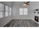 Bright, airy living room filled with natural light, hardwood floors and a cozy fireplace at 102 Manley Ct, Woodstock, GA 30188