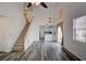 Spacious living room with hardwood floors, open staircase, and modern lighting at 102 Manley Ct, Woodstock, GA 30188