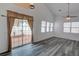 Bright and open living room with large windows, sliding glass doors and hardwood floors at 102 Manley Ct, Woodstock, GA 30188