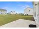 Expansive backyard with a patio surrounded by verdant green grass at 1052 Bodega Loop, Locust Grove, GA 30248