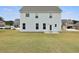 Wide backyard of two story house, featuring lush green grass and neighbors at 1052 Bodega Loop, Locust Grove, GA 30248