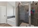 Bathroom featuring a large bathtub, and shower with dark tiling and glass doors at 1052 Bodega Loop, Locust Grove, GA 30248
