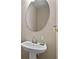 Powder room featuring stylish pedestal sink and an oval mirror at 1052 Bodega Loop, Locust Grove, GA 30248