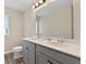 Bathroom featuring double sinks, modern vanity, large mirror, and stylish lighting at 1052 Bodega Loop, Locust Grove, GA 30248