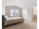 Comfortable bedroom with natural light from double window and ensuite bathroom at 1052 Bodega Loop, Locust Grove, GA 30248