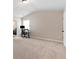 Spacious bedroom with neutral walls and carpet flooring, ceiling fan, and a view of desk/office setup at 1052 Bodega Loop, Locust Grove, GA 30248