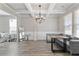Elegant dining room featuring coffered ceilings, hardwood floors, and modern lighting fixtures at 1052 Bodega Loop, Locust Grove, GA 30248