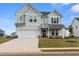 Charming two-story home with a manicured lawn, inviting curb appeal, and an attached two-car garage at 1052 Bodega Loop, Locust Grove, GA 30248