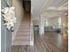 Inviting foyer with staircase, beautiful hardwood floors, and views into the spacious living room area at 1052 Bodega Loop, Locust Grove, GA 30248