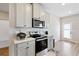 Well-equipped kitchen with stainless appliances, gray cabinets, quartz counters, and herringbone backsplash at 1052 Bodega Loop, Locust Grove, GA 30248