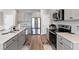 Well-appointed kitchen features stainless steel appliances, gray cabinets, and a functional layout at 1052 Bodega Loop, Locust Grove, GA 30248