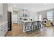 Spacious kitchen with stone countertops, island with bar seating, stainless steel appliances, and hardwood floors at 1052 Bodega Loop, Locust Grove, GA 30248