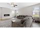 Spacious living room with a modern fireplace, plush seating, and lots of natural light at 1052 Bodega Loop, Locust Grove, GA 30248