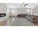 Bright living room featuring fireplace, plush sofa, hardwood floors, and lots of natural light at 1052 Bodega Loop, Locust Grove, GA 30248