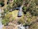 Birds-eye view of a secluded home surrounded by vibrant greenery and a long winding driveway at 3227 Heritage Way, Buford, GA 30519