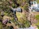 Aerial view of a secluded home nestled among lush greenery, showcasing a long driveway and private setting at 3227 Heritage Way, Buford, GA 30519