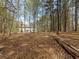 Wooded area with view of backyard and rear exterior of the home at 3227 Heritage Way, Buford, GA 30519