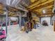 Spacious unfinished basement with tools, equipment, and garage door at 3227 Heritage Way, Buford, GA 30519