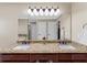 Bathroom featuring granite countertop with double sinks and dark wood cabinets at 3227 Heritage Way, Buford, GA 30519