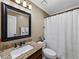 Bathroom featuring granite countertop with vessel sink and shower with a white curtain at 3227 Heritage Way, Buford, GA 30519