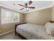Neutral bedroom featuring a ceiling fan, window, and a comfortable bed at 3227 Heritage Way, Buford, GA 30519