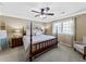Cozy bedroom featuring a four-poster bed, ceiling fan, and natural light at 3227 Heritage Way, Buford, GA 30519
