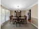 Dining room with hardwood floors and crown molding features a china cabinet and wainscoting at 3227 Heritage Way, Buford, GA 30519