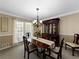 Dining room with hardwood floors and crown molding features a china cabinet and wainscoting at 3227 Heritage Way, Buford, GA 30519