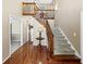 Welcoming foyer featuring hardwood floors, stairs with carpet, and natural lighting at 3227 Heritage Way, Buford, GA 30519